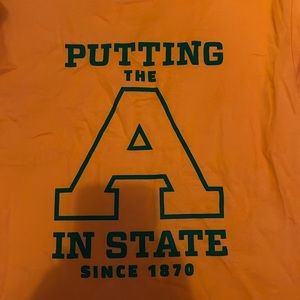 Orange shirt from AG “putting the A in state since 1870”